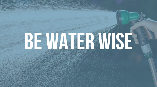 A graphic with text, the image is of a hose being sprayed, the text is "Be water wise"