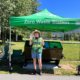 An AWARE employee stands under a Zero Waste canopy at Whistler Parks.